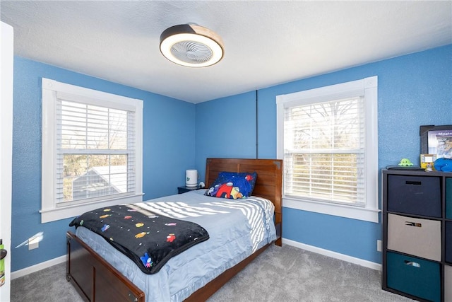 bedroom with carpet floors and multiple windows