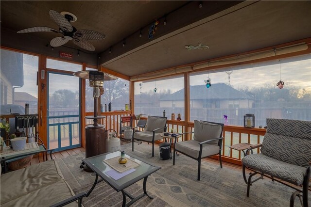 sunroom featuring ceiling fan