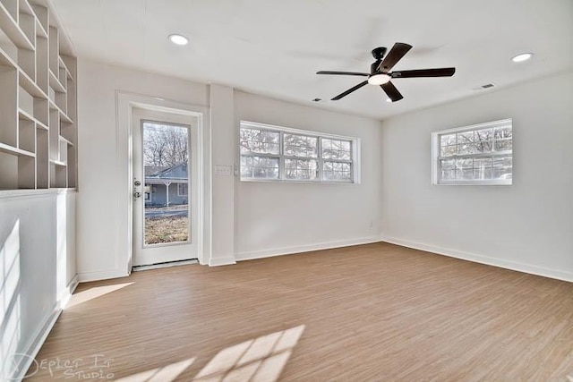 spare room featuring ceiling fan, plenty of natural light, and light hardwood / wood-style floors