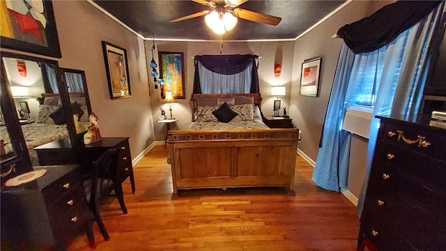 bedroom with hardwood / wood-style floors, ceiling fan, and ornamental molding