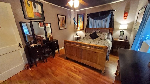 bedroom with ceiling fan and hardwood / wood-style flooring