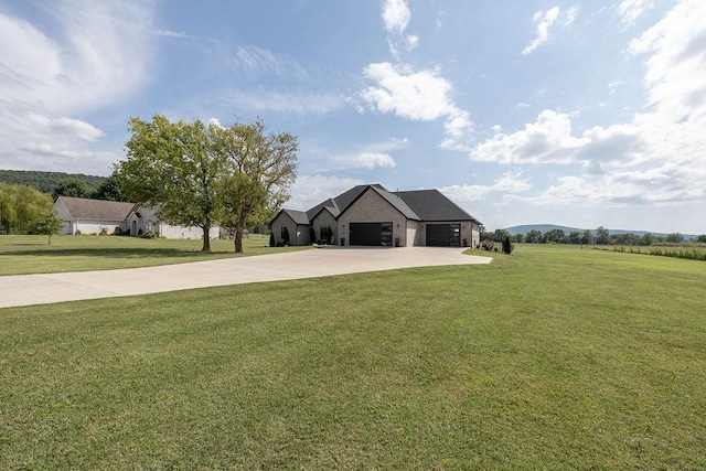 view of front of house featuring a garage and a front lawn