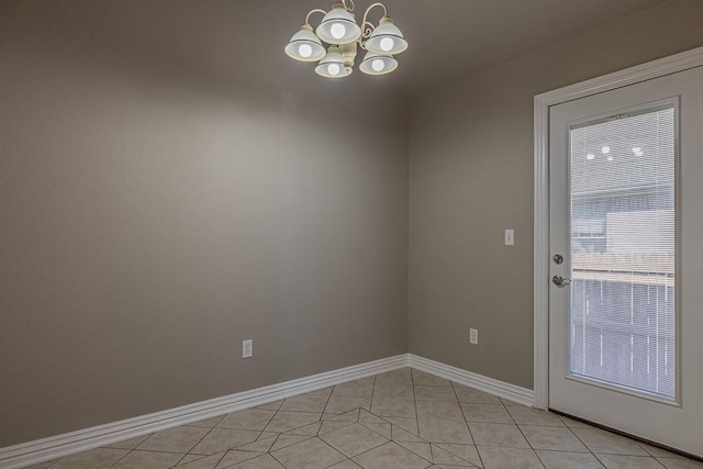 entryway featuring light tile patterned floors and an inviting chandelier