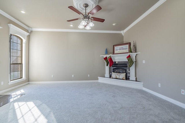 interior space featuring carpet floors, a wealth of natural light, ornamental molding, and ceiling fan