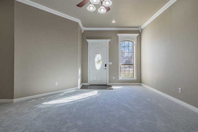 foyer entrance with carpet, ceiling fan, and crown molding