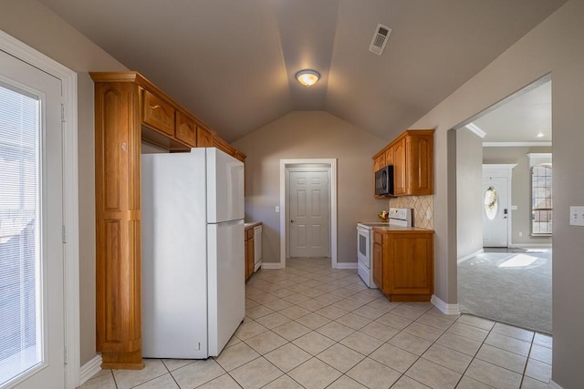 kitchen featuring plenty of natural light, white appliances, and light tile patterned floors