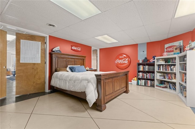 tiled bedroom featuring a paneled ceiling