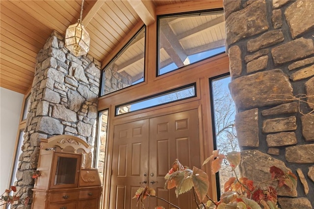 interior space featuring beamed ceiling, wooden ceiling, and high vaulted ceiling