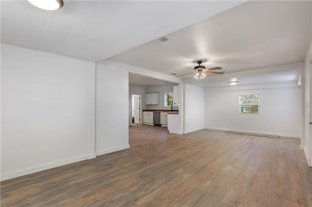 unfurnished living room featuring hardwood / wood-style flooring and ceiling fan