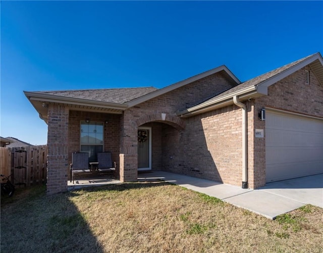 ranch-style home with a front yard and a garage