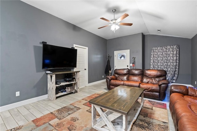 living room featuring ceiling fan, light hardwood / wood-style floors, and vaulted ceiling