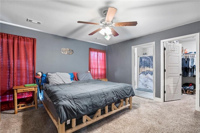 carpeted bedroom featuring ensuite bath, ceiling fan, a closet, and a spacious closet