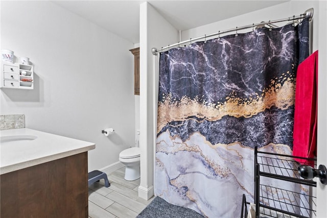 bathroom featuring vanity, toilet, and wood-type flooring