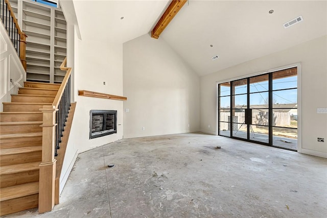 unfurnished living room with beam ceiling and high vaulted ceiling