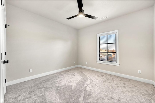 carpeted spare room featuring ceiling fan