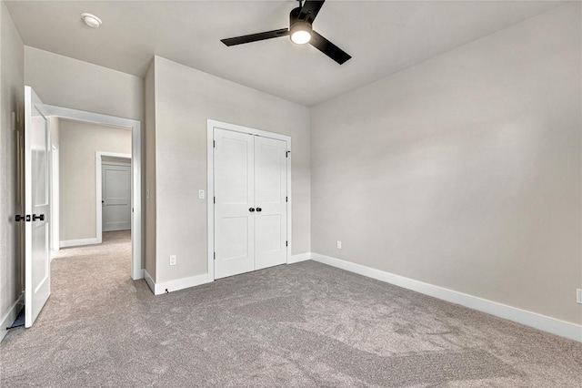 unfurnished bedroom featuring carpet flooring, ceiling fan, and a closet