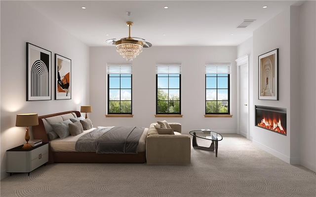 bedroom featuring light colored carpet and an inviting chandelier