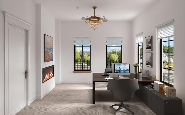 office space featuring light carpet and an inviting chandelier