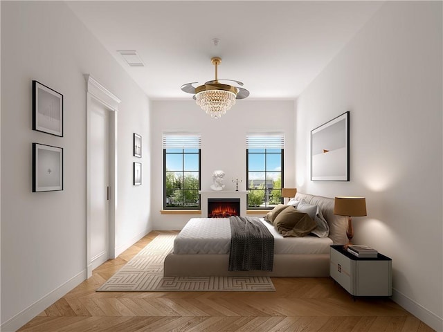 bedroom featuring light parquet flooring and an inviting chandelier