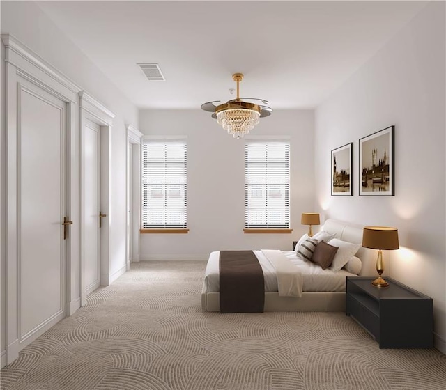 carpeted bedroom with a notable chandelier