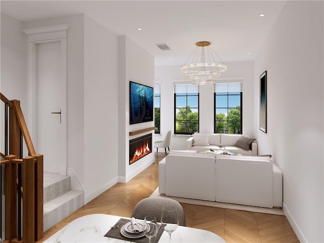 living room with a chandelier and light parquet flooring