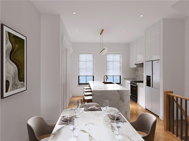 dining area with light parquet flooring and sink