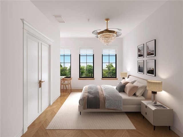 bedroom featuring light parquet floors and a notable chandelier