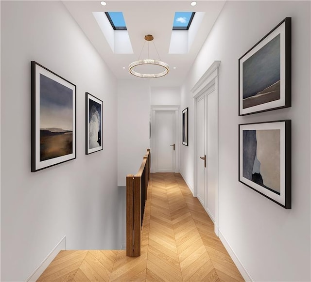 hallway with light parquet flooring and an inviting chandelier