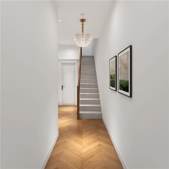 corridor featuring a chandelier and parquet flooring