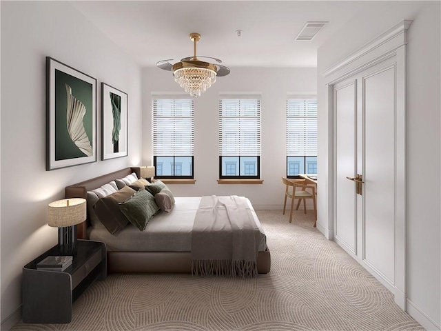 carpeted bedroom with a notable chandelier