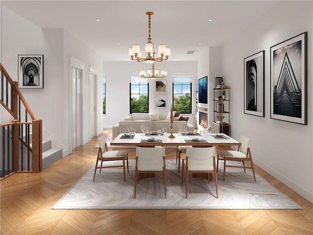 dining space with an inviting chandelier and light parquet flooring