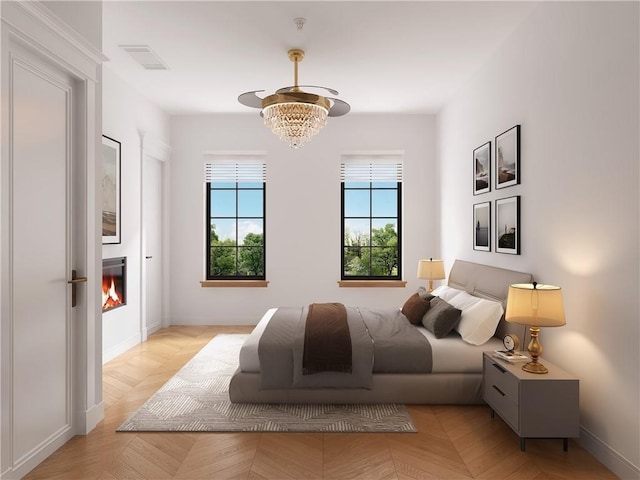 bedroom featuring light parquet flooring and an inviting chandelier