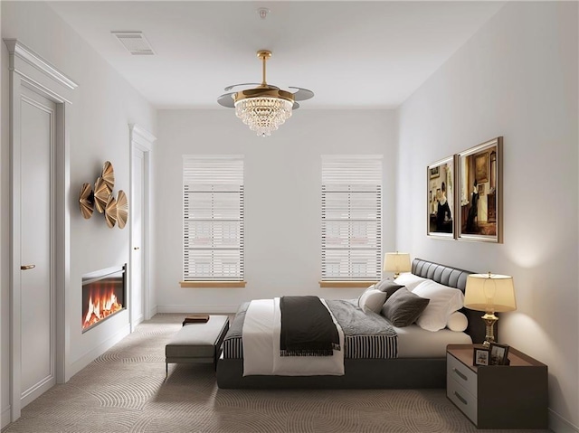 bedroom with carpet flooring and an inviting chandelier