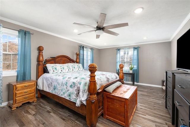 bedroom featuring ceiling fan, ornamental molding, dark wood-type flooring, and multiple windows