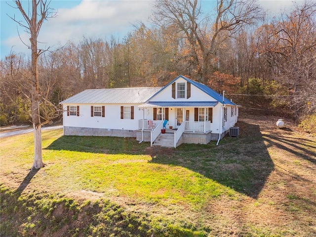 view of front facade featuring covered porch, central AC unit, and a front lawn