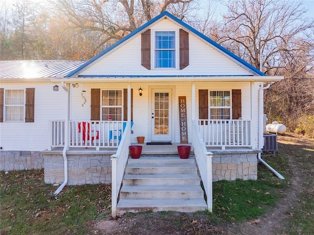 view of front of property with covered porch and central AC unit