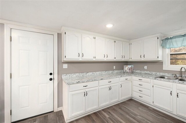 kitchen with dark hardwood / wood-style floors, white cabinetry, and sink