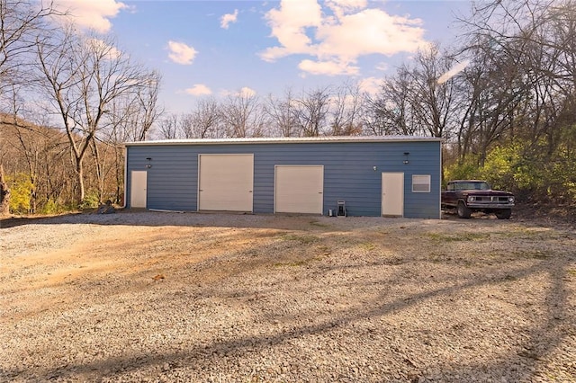 view of garage at dusk