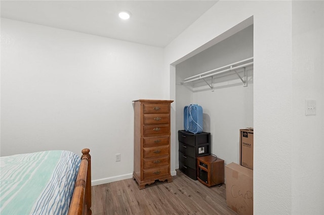 bedroom with light hardwood / wood-style flooring and a closet