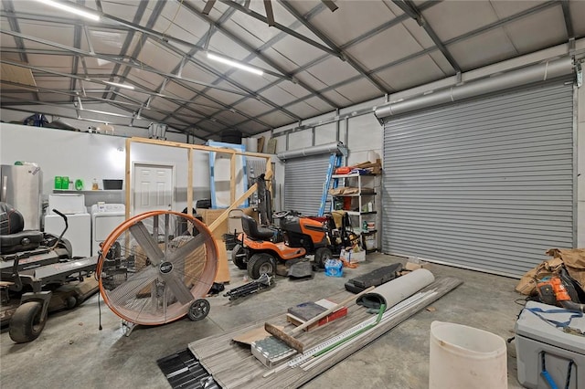 garage featuring stainless steel refrigerator and washer and dryer