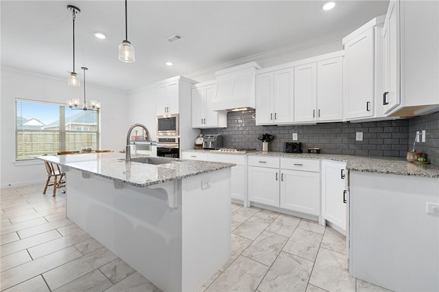 kitchen featuring white cabinets, pendant lighting, sink, and stainless steel appliances