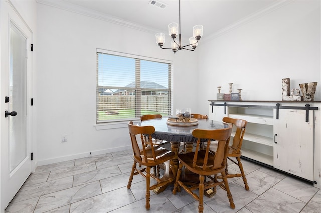 dining space featuring a barn door, an inviting chandelier, and ornamental molding