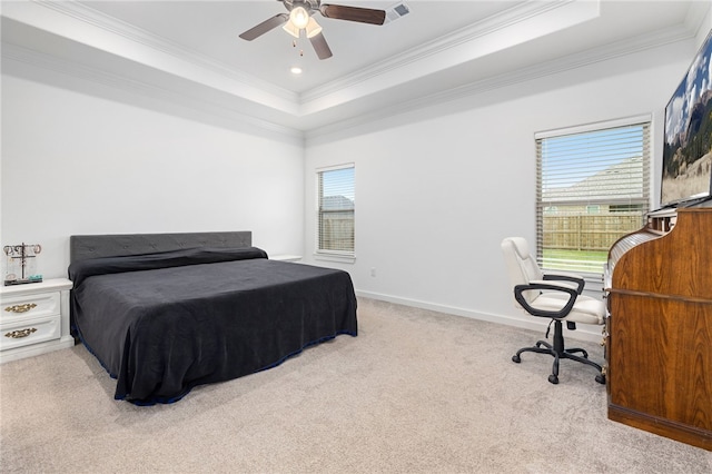 carpeted bedroom with multiple windows, a raised ceiling, ceiling fan, and crown molding