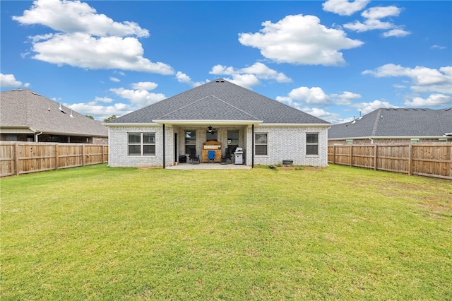 back of house with a yard, ceiling fan, and a patio area