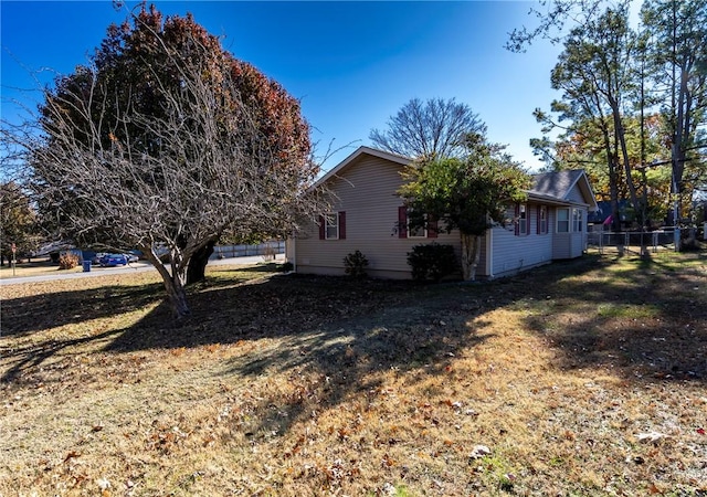 view of side of property with a yard