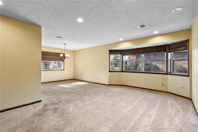 interior space featuring a chandelier, a textured ceiling, and carpet floors