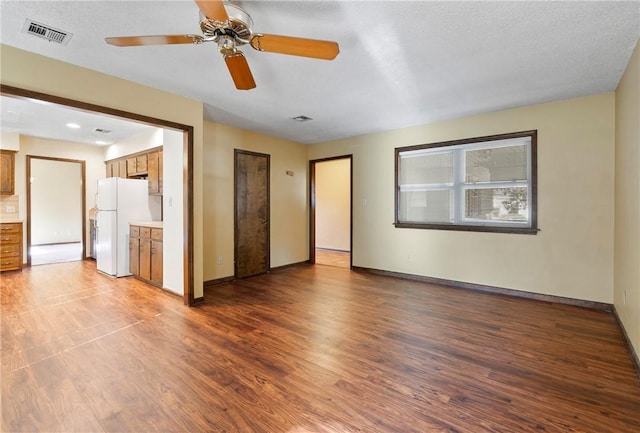 unfurnished room with hardwood / wood-style flooring, ceiling fan, and a textured ceiling