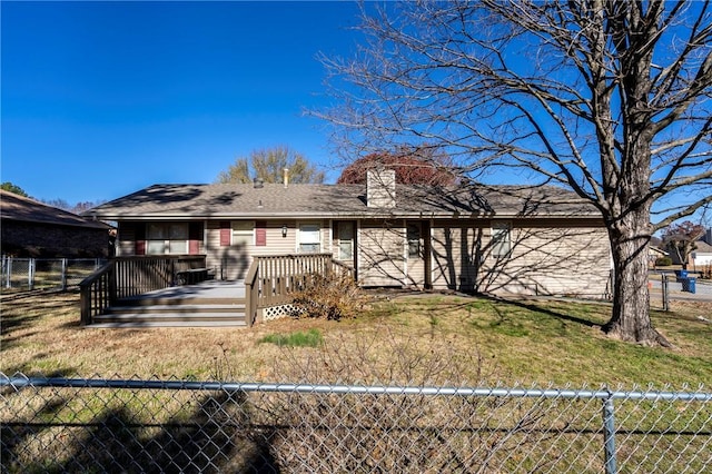 view of front facade with a front yard and a wooden deck