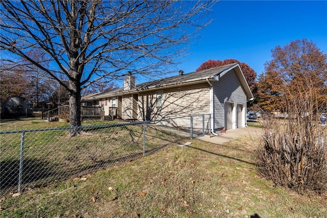 view of home's exterior with a garage and a yard