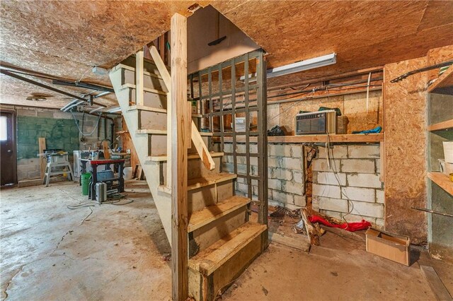 basement with a wall mounted air conditioner